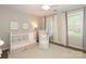 Bright Bedroom with white crib, a cozy armchair, and large windows; perfect for a new baby at 6910 Green Turtle Dr, Charlotte, NC 28210
