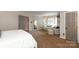 Spacious bedroom with a seating area, great natural light, and neutral tones, perfect for a relaxing retreat at 6910 Green Turtle Dr, Charlotte, NC 28210