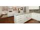 Bright kitchen with granite counters, white cabinets, and hardwood floors at 6910 Green Turtle Dr, Charlotte, NC 28210