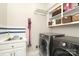 Well-equipped laundry room features modern washer and dryer, sink, and ample shelving at 6910 Green Turtle Dr, Charlotte, NC 28210