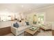 Bright living room flows into an open kitchen with hardwood floors and backyard access through glass doors at 6910 Green Turtle Dr, Charlotte, NC 28210