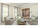 Bright sitting room with comfortable chairs, a round glass table, and large windows at 6910 Green Turtle Dr, Charlotte, NC 28210