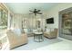 Inviting screened porch featuring wicker furniture, ceiling fan, and views of the surrounding landscape at 6910 Green Turtle Dr, Charlotte, NC 28210
