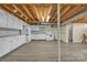 A basement kitchen area with white cabinets, an oven, and exposed ceiling at 70 Liberty Church Rd, Taylorsville, NC 28681