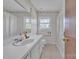 A classic bathroom features a white vanity and neutral-patterned wallpaper at 70 Liberty Church Rd, Taylorsville, NC 28681