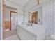 A functional bathroom features a large mirror and patterned wallpaper accents at 70 Liberty Church Rd, Taylorsville, NC 28681