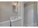 The bathroom has wallpaper, a modern mirror, vanity with modern faucet, and a walk-in shower at 70 Liberty Church Rd, Taylorsville, NC 28681