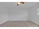 A simple bedroom features neutral carpet and a ceiling fan at 70 Liberty Church Rd, Taylorsville, NC 28681