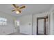 This is a bedroom with neutral walls, a ceiling fan, and an ensuite bathroom with patterned wallpaper at 70 Liberty Church Rd, Taylorsville, NC 28681