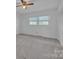 A bright bedroom has neutral carpet, a ceiling fan, and a double window at 70 Liberty Church Rd, Taylorsville, NC 28681
