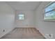 Neutral colored walls and carpet add a charming feel to this room with two windows at 70 Liberty Church Rd, Taylorsville, NC 28681