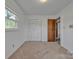 This is a carpeted room with two windows and a large closet at 70 Liberty Church Rd, Taylorsville, NC 28681