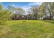 Expansive front yard view of a traditional brick ranch-style home on a sunny day at 70 Liberty Church Rd, Taylorsville, NC 28681