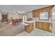 An open kitchen features wood cabinets and connects to a carpeted dining area at 70 Liberty Church Rd, Taylorsville, NC 28681