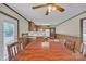 A dining area includes a wood table next to a kitchen with white counters and wood cabinets at 70 Liberty Church Rd, Taylorsville, NC 28681