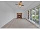 Cozy living room with a classic brick fireplace and large windows offering natural light at 70 Liberty Church Rd, Taylorsville, NC 28681
