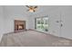 Bright living room featuring a brick fireplace, ceiling fan, and large windows with a view at 70 Liberty Church Rd, Taylorsville, NC 28681