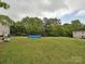 Large backyard with an above ground pool and trees at 7024 Sunman Rd, Charlotte, NC 28216