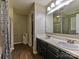 Bathroom featuring a double sink vanity with wood-look flooring at 7024 Sunman Rd, Charlotte, NC 28216
