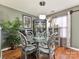 Inviting dining room featuring glass table, unique chairs, and stylish decor by large window at 7024 Sunman Rd, Charlotte, NC 28216