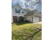 Charming home with a well-maintained lawn, brick accents, and an attached two-car garage at 7024 Sunman Rd, Charlotte, NC 28216