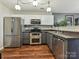 Well-equipped kitchen featuring stainless steel appliances, ample counter space, and modern fixtures at 7024 Sunman Rd, Charlotte, NC 28216