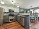 Open kitchen with stainless steel appliances, stylish cabinets, and seamlessly connects to the dining area at 7024 Sunman Rd, Charlotte, NC 28216
