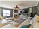 Bright living room with a fireplace, ceiling fan, large TV, and comfortable, contemporary seating at 7024 Sunman Rd, Charlotte, NC 28216