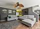 Stylish living room with gray brick accent wall, modern furniture, and unique ceiling fan at 7024 Sunman Rd, Charlotte, NC 28216