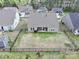 Aerial view showcasing home with spacious, fenced backyard and covered patio area at 7633 Tanglewood Way, Denver, NC 28037