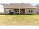 Well-maintained backyard with a covered patio area and a black grill at 7633 Tanglewood Way, Denver, NC 28037