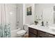 Bathroom featuring vanity, shower/tub with shower curtain and updated fixtures at 7633 Tanglewood Way, Denver, NC 28037