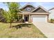Charming single-Gathering home featuring a two-car garage and landscaped front yard at 7633 Tanglewood Way, Denver, NC 28037