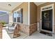 Inviting front porch showcases comfortable seating and decorative wreath on door at 7633 Tanglewood Way, Denver, NC 28037