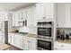 Updated kitchen boasts stainless steel appliances, gas range, subway tile backsplash, and modern cabinets at 7633 Tanglewood Way, Denver, NC 28037