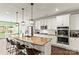 Gourmet kitchen with granite countertops, stainless appliances, island with bar seating, and pendant lighting at 7633 Tanglewood Way, Denver, NC 28037