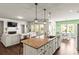 Open concept living featuring a kitchen with large island, pendant lighting, and adjacent living and dining areas at 7633 Tanglewood Way, Denver, NC 28037