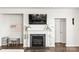 Cozy living room features a modern fireplace with mantle, tv, and beautiful flooring at 7633 Tanglewood Way, Denver, NC 28037