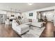 This bright open concept living space includes a spacious couch and a modern kitchen at 7633 Tanglewood Way, Denver, NC 28037