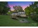 Expansive backyard with a multi-level deck and a cozy fire pit area at 8025 Cliffside Dr, Charlotte, NC 28270