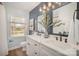 Bathroom featuring double sinks, vanity, mirrors, and a window at 8025 Cliffside Dr, Charlotte, NC 28270