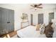 A light-filled bedroom with hard wood floors, ceiling fan, and multiple closets at 8025 Cliffside Dr, Charlotte, NC 28270