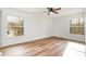 Bright bedroom with hardwood floors, ceiling fan, and a large window at 8025 Cliffside Dr, Charlotte, NC 28270