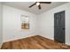 Cozy bedroom featuring hardwood floors, neutral walls and a modern ceiling fan at 8025 Cliffside Dr, Charlotte, NC 28270