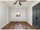 Minimalist bedroom with hardwood floors and a modern ceiling fan at 8025 Cliffside Dr, Charlotte, NC 28270