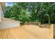 Wooden deck showcases the backyard surrounded by mature trees offering a private outdoor space at 8025 Cliffside Dr, Charlotte, NC 28270