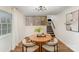 Basement dining area with modern furnishings and open stairs to the main living area at 8025 Cliffside Dr, Charlotte, NC 28270