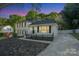 Charming home with black shutters, a well-manicured lawn and a quaint white picket fence at 8025 Cliffside Dr, Charlotte, NC 28270