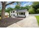 Exterior view of a charming home with a well manicured lawn, landscaping and driveway at 8025 Cliffside Dr, Charlotte, NC 28270