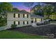 Charming two-story home featuring a well-manicured lawn and inviting front porch at 8025 Cliffside Dr, Charlotte, NC 28270